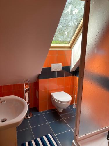 a bathroom with a toilet and a sink at Chata Severka in Dolný Kubín