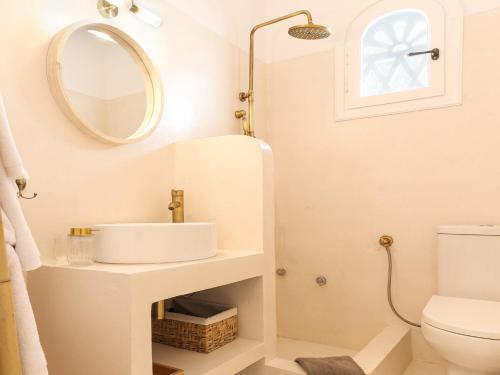 a bathroom with a sink and a mirror at La Vista TINOS in Agios Ioannis