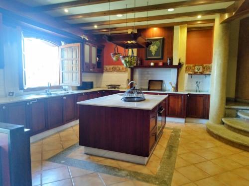 a large kitchen with a island in the middle at Villa María in Ardán