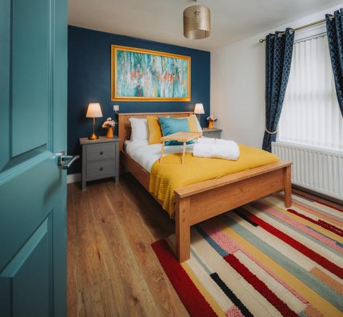 a bedroom with a bed with a yellow blanket at Cosy Hot Tub Getaway Bungalow in Armagh