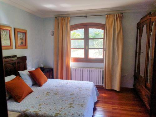 a bedroom with a large bed and a window at Villa María in Ardán