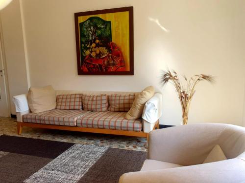 a living room with a couch and a painting on the wall at Chiavari Beach in Chiavari
