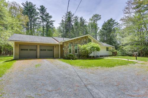 a house with a garage and a driveway at Charming Swan Lake Apartment with Deck! in Swan Lake