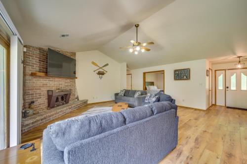 a living room with a blue couch and a fireplace at Family, Friends and Fishing Home Near Grand Lake in Grove