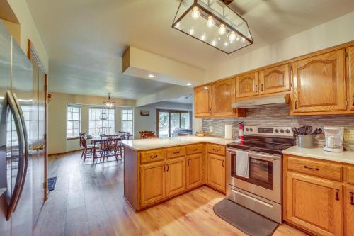 a kitchen with wooden cabinets and a dining room at Family, Friends and Fishing Home Near Grand Lake in Grove