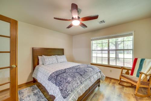 a bedroom with a bed and a ceiling fan at Family, Friends and Fishing Home Near Grand Lake in Grove