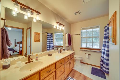 a bathroom with a sink and a mirror and a toilet at Family, Friends and Fishing Home Near Grand Lake in Grove
