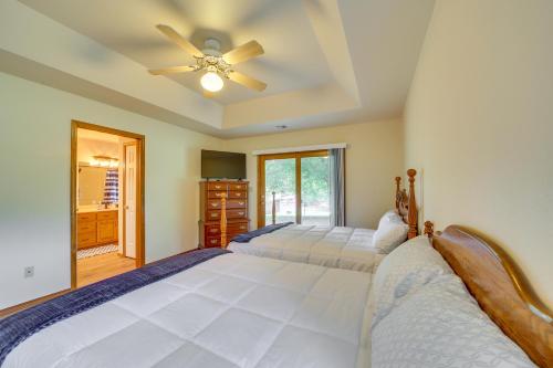 a bedroom with two beds and a ceiling fan at Family, Friends and Fishing Home Near Grand Lake in Grove