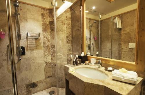 a bathroom with a sink and a shower at Cristal Palace Hotel in Madonna di Campiglio