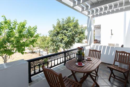 a patio with a table and chairs on a balcony at Sea Lilies Suites in Plaka