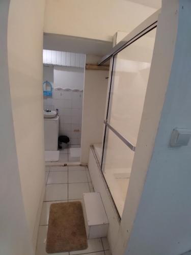 a small bathroom with a toilet and a window at Calinago Friendly Family Sxm in Philipsburg