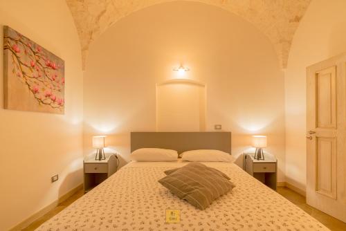a bedroom with a large bed with two night stands at Petralù - Casa Vacanza zona centro in Locorotondo