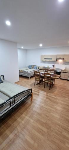 a room with two beds and tables and chairs at APARTMAN MURKO P-4 in Ljubljana