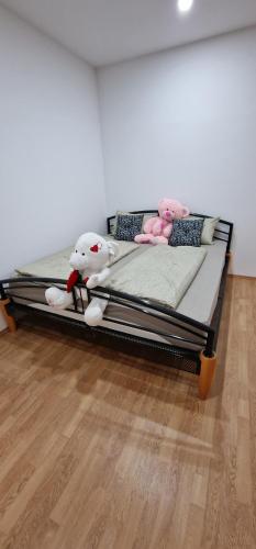 a bed with stuffed animals on it in a room at APARTMAN MURKO P-4 in Ljubljana