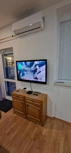 a living room with a flat screen tv on a wall at APARTMAN MURKO P-4 in Ljubljana
