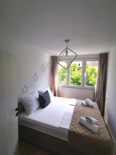 a bedroom with a bed with two towels on it at City Center Apartment Bravos in Makarska