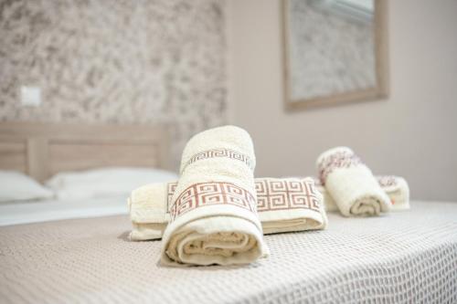 a hotel room with towels on a bed at Old Town Elpis Suite in Kos Town