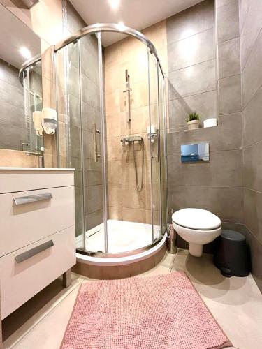 a bathroom with a shower and a toilet at Studio Krakow Center in Kraków