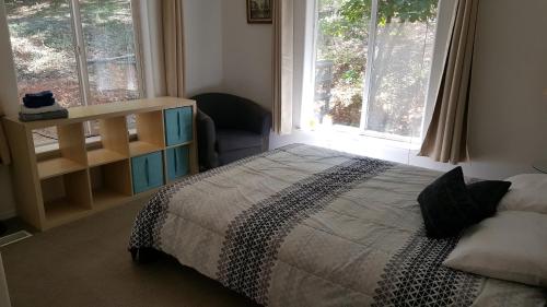 a bedroom with a bed and a large window at Explore Amador and Calaveras County. in West Point