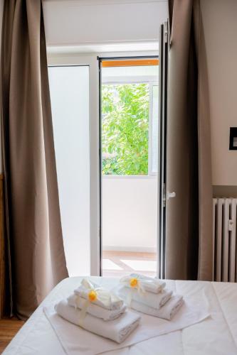 a bed with three folded towels on top of it at CALVANI23 LUXURY HOUSE in Bari