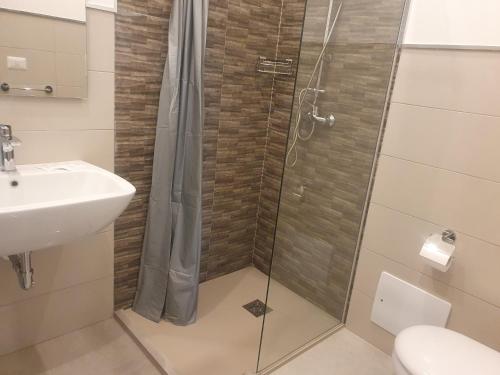 La salle de bains est pourvue d'une douche et d'un lavabo. dans l'établissement SeA Beach Home, à Torre Lapillo