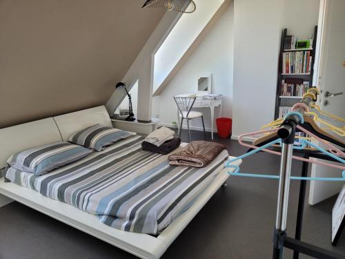 a bed in a room with a stairway at Chambre chez particulier 10mn du circuit in Changé