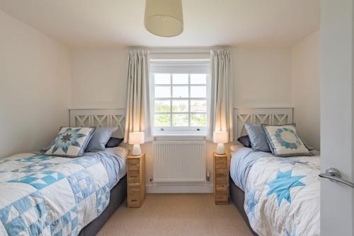 a bedroom with two beds and a window at Vine Cottage by Bloom Stays in Canterbury