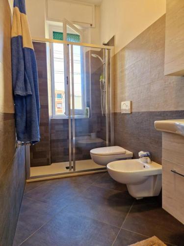 a bathroom with a shower and a toilet and a sink at Chiavari Beach in Chiavari