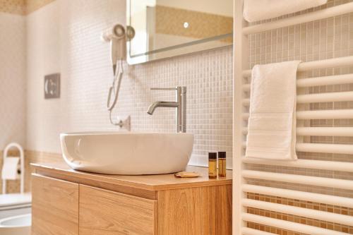 een badkamer met een witte wastafel en een bad bij Conchiglia & Medusa Home Otranto in Otranto