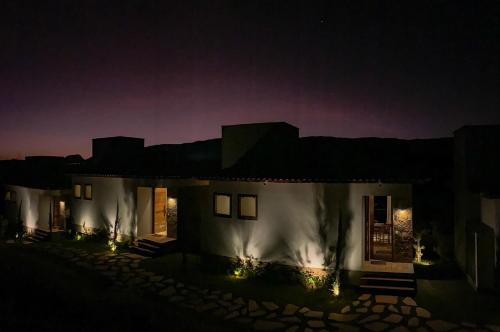 a house lit up at night with lights at Lofts Villa Gratiam in Tiradentes