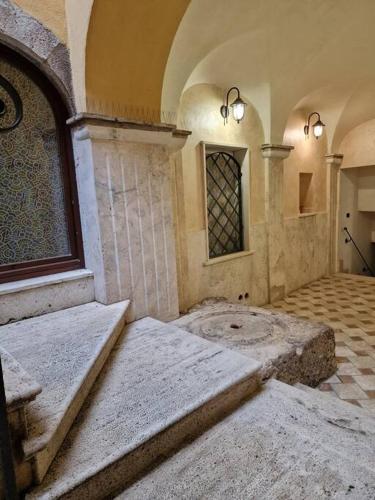 an empty room with a stone floor and a window at Dimora Charme in Monterotondo