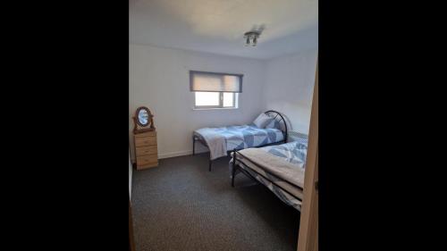 a small room with two beds and a window at Remarkable 2-Bed Apartment in Central Liverpool in Liverpool