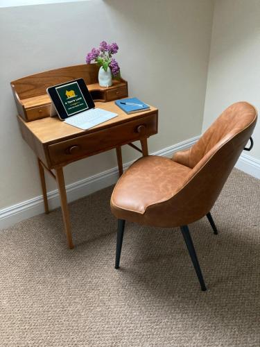 a desk with a chair and a laptop on it at 4 Tom's Lane in Bantry