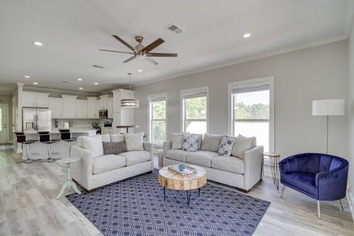 a living room with two couches and a table at Pet-Friendly Vacation Rental in Biloxi Near Beach! in Biloxi