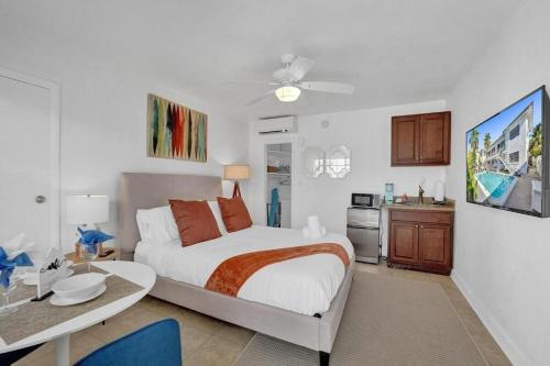 a bedroom with a bed and a table and a kitchen at Waves On Desoto Lovely Studio # 2 in Hollywood
