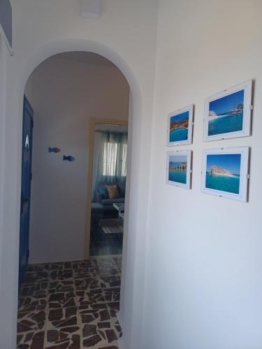 an archway in a room with pictures on the wall at Orizodas in Lipsoi
