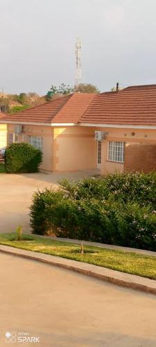 a house with a driveway in front of it at Stream Box Lodge in Lilongwe