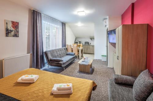 a small living room with a table and a couch at Elendris - Ubytování u kostela in Brno