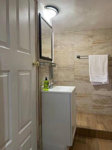 a bathroom with a white sink and a mirror at Suite Mirador Deluxe in Chihuahua