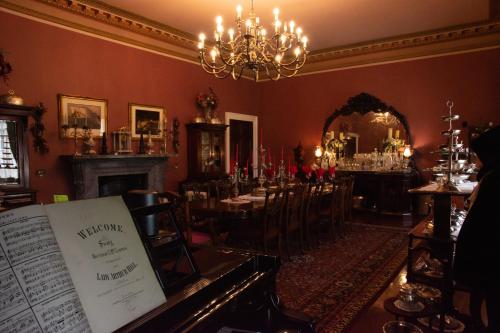 a dining room with a table and a chandelier at Quernmore Park Hall in Lancaster
