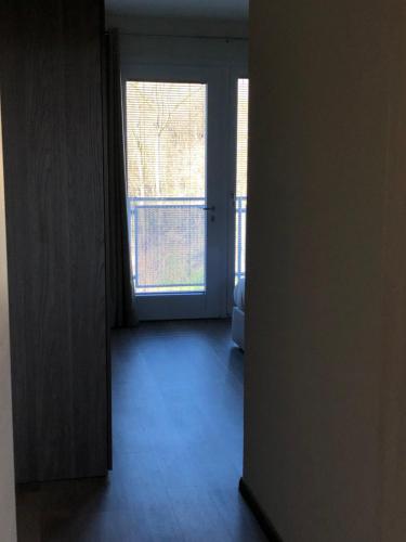 an open door to a room with a window at Prealpina Hotel in Bagnolo Piemonte