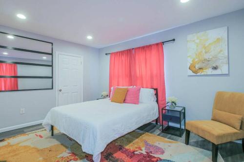 a bedroom with a bed and a chair at Vibrant Island Home - 3 Bedrooms and 2 Bathrooms in Atlantic City