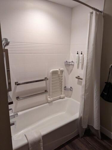 a white bathroom with a tub and a shower at TownePlace Suites By Marriott Columbia West/Lexington in West Columbia