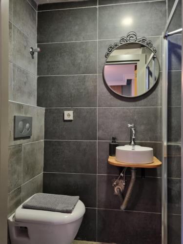 a bathroom with a toilet and a mirror at El Mundo Suites in Antalya