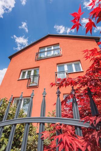 a red brick building with windows and a tree at Elendris - Ubytování u kostela in Brno
