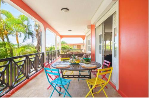a patio with a table and chairs on a balcony at Sunshine Villa in Le Moule