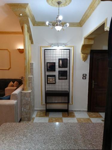 a living room with a couch and a chandelier at Yaso Roof & Apartments in Amman