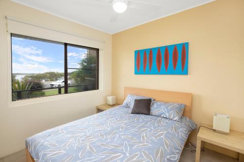 a bedroom with a bed and a window at Wallis View 3 in Forster
