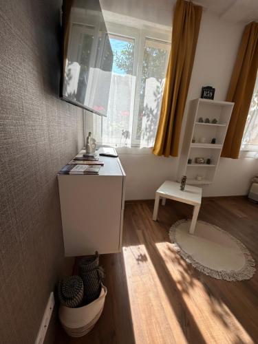 a desk in a room with a window at R59 Apartman with free parking in Pécs