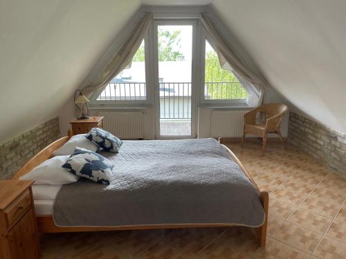 a bedroom with a bed with pillows on it at Apartamenty Ogrodowa in Jastarnia